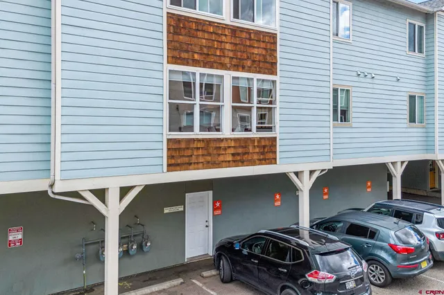 a view of parking garage with cars