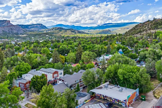 an aerial view of a house with a yard