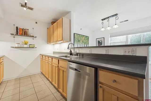 a kitchen with stainless steel appliances a sink stove and cabinets
