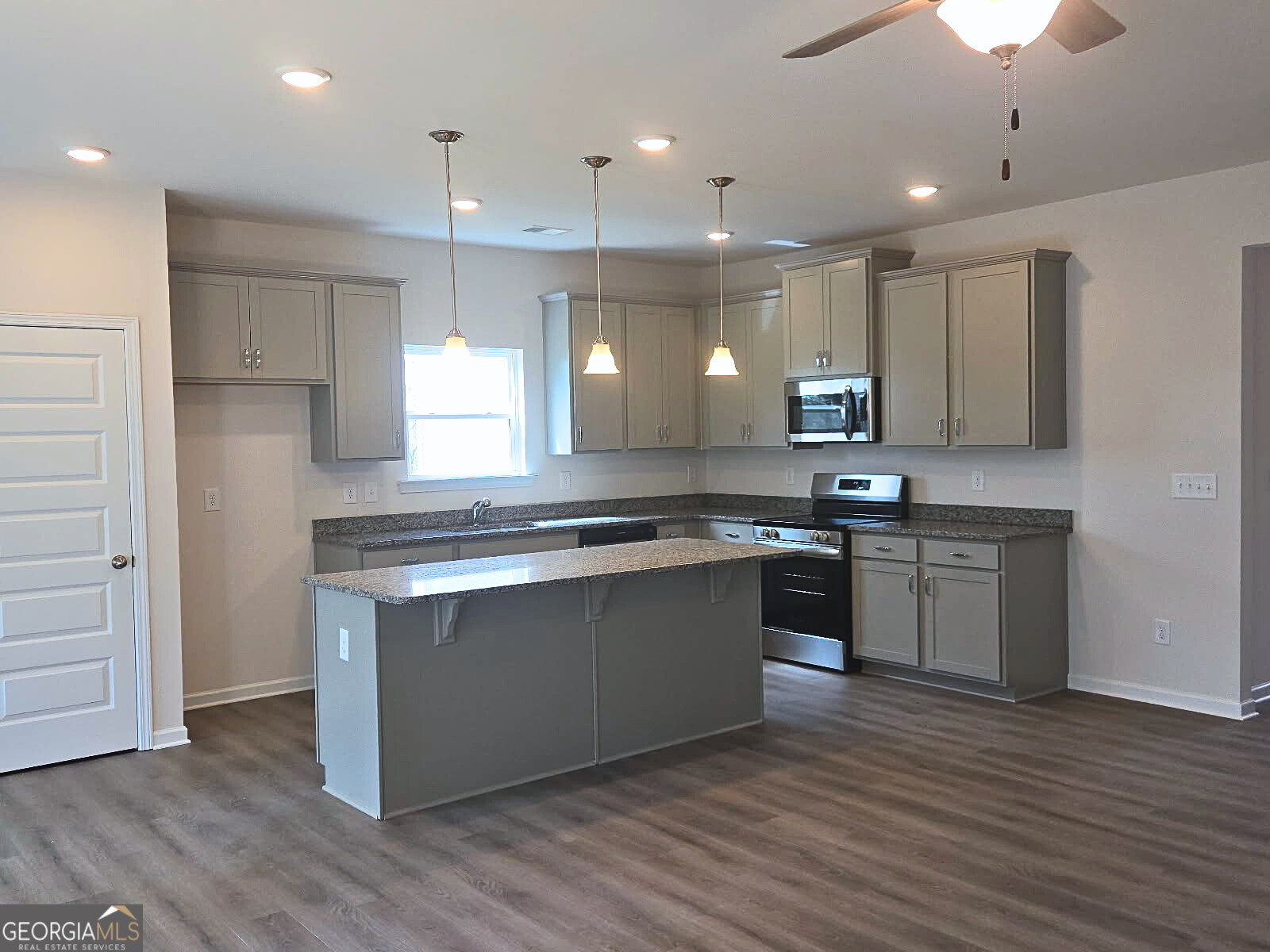157 Creekside Road, Unit (LOT 32) Eatonton, GA 31024 - Photo 2 of 28 a large kitchen with stainless steel appliances granite countertop a stove a sink and a refrigerator