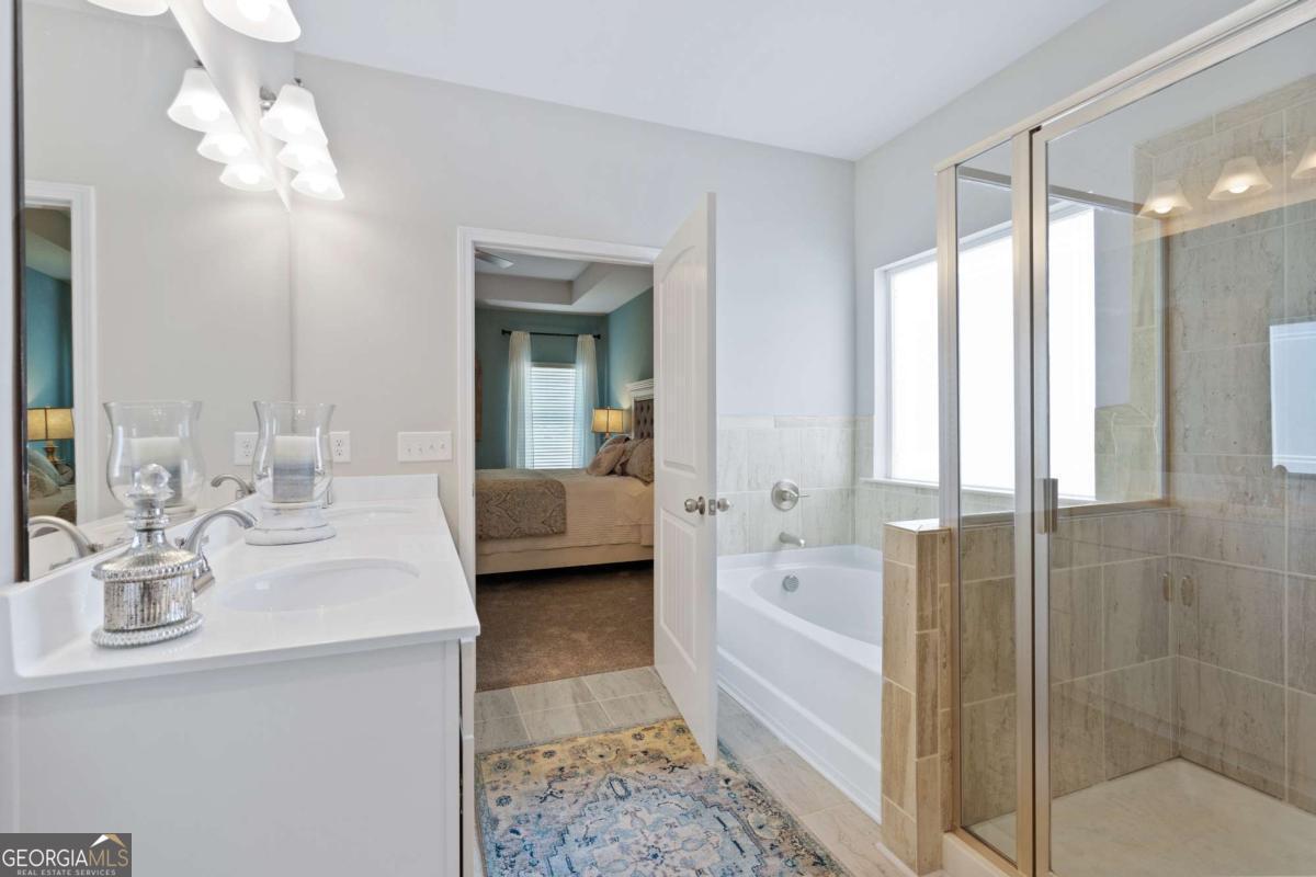 157 Creekside Road, Unit (LOT 32) Eatonton, GA 31024 - Photo 22 of 28 a bathroom with a tub sink shower and mirror