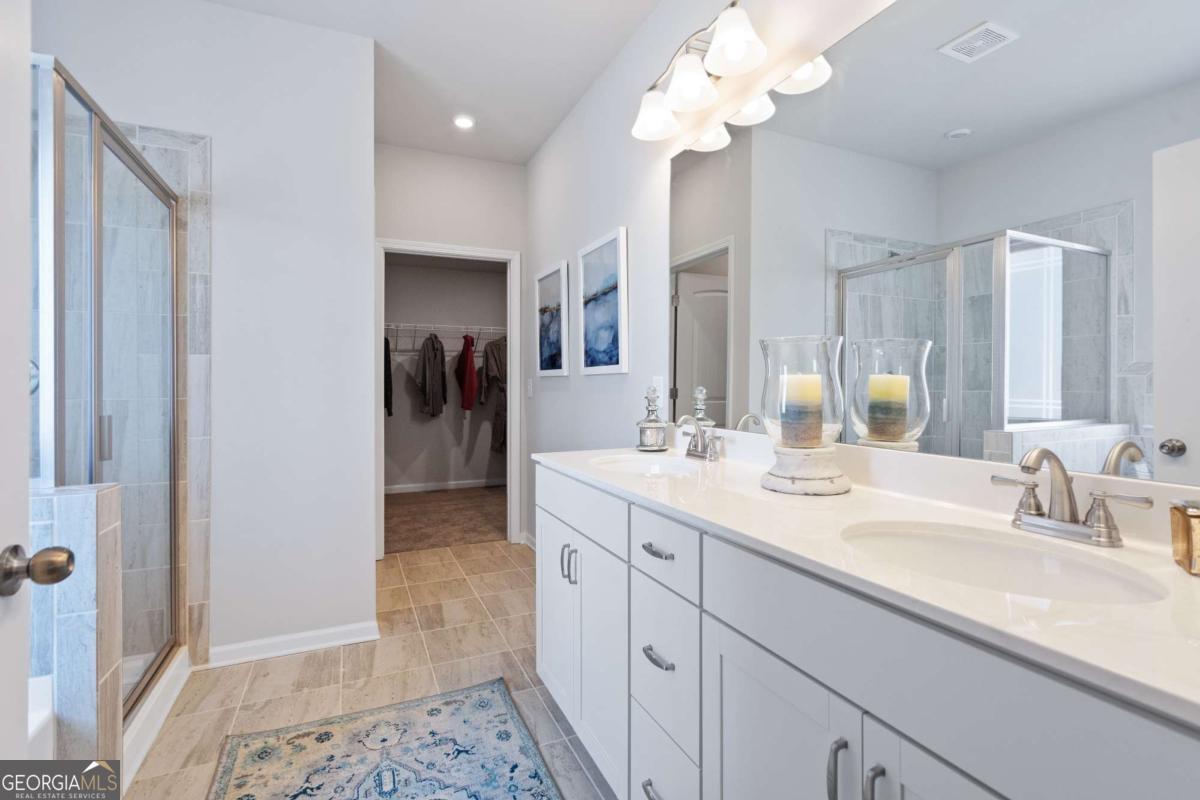 157 Creekside Road, Unit (LOT 32) Eatonton, GA 31024 - Photo 25 of 28 a bathroom with a sink a vanity and a mirror