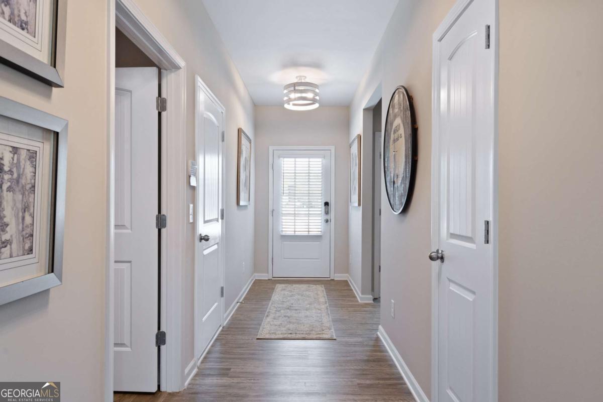 157 Creekside Road, Unit (LOT 32) Eatonton, GA 31024 - Photo 6 of 28 a view of a hallway with wooden floor