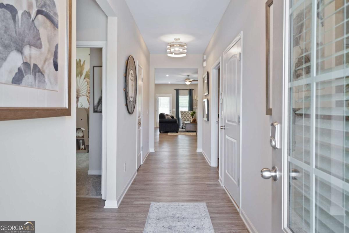 157 Creekside Road, Unit (LOT 32) Eatonton, GA 31024 - Photo 7 of 28 a view of a hallway with wooden floor