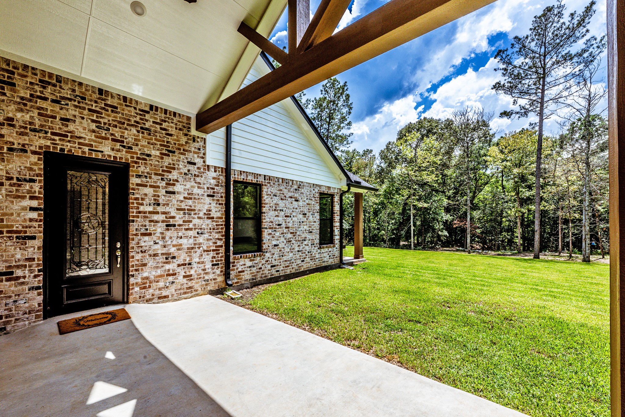 111 Eagle Run Road Willis, TX 77378 - Photo 29 of 44 Charming covered porch connecting the main house and guest house, with direct access to the guest house.