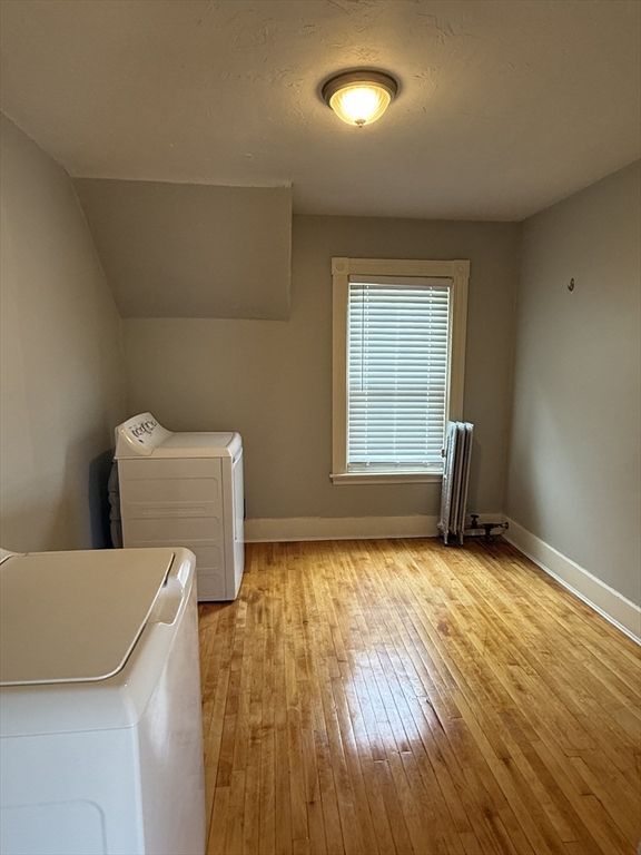 5 Arbor Vitae Street, Unit 2 Worcester, MA 01603 - Photo 10 of 12 a view of an empty room with a window and wooden floor