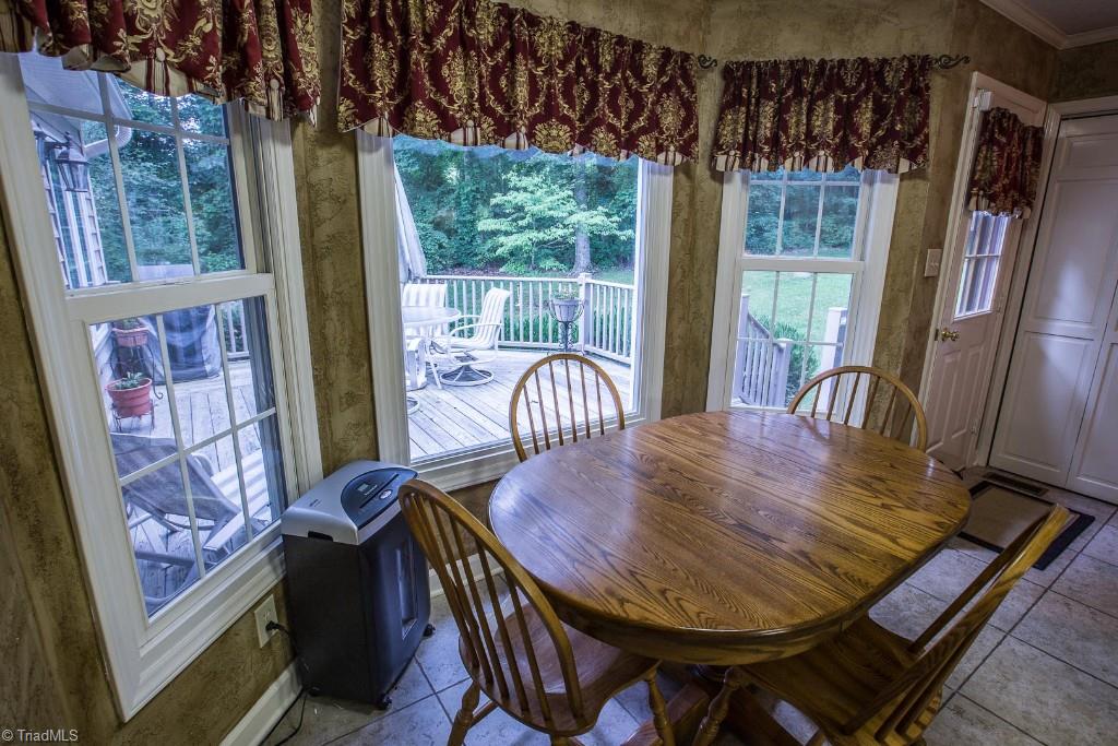 5707 Roundtable Road Greensboro, NC 27407 - Photo 10 of 29 Decompress looking over deck and private backyard at meal time. Bay window effect. Laundry conveniently off kitchen.