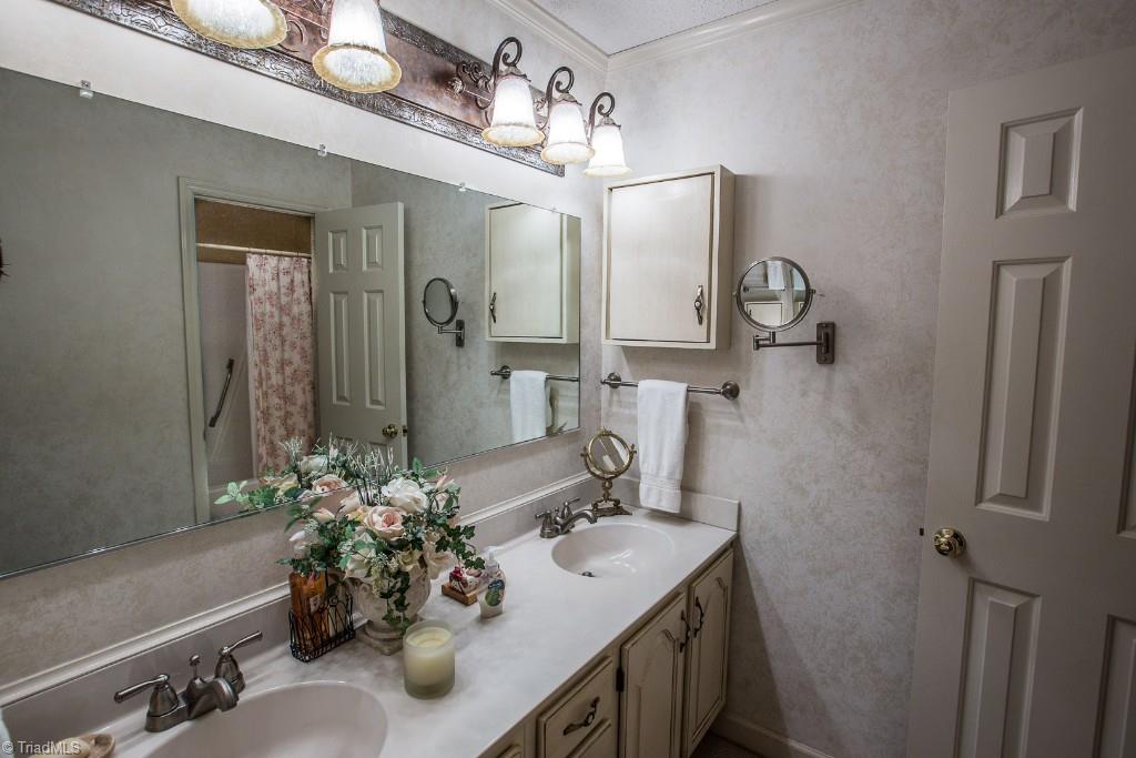 5707 Roundtable Road Greensboro, NC 27407 - Photo 14 of 29 Dressing Area with two sinks, medicine cabinet, beautiful lighting. Private WC and tub-shower. Walk-in closet. You have it all!