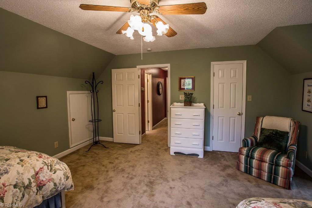 5707 Roundtable Road Greensboro, NC 27407 - Photo 17 of 29 Upstairs bedroom off to one side has large closet and wonderful eaves storage.