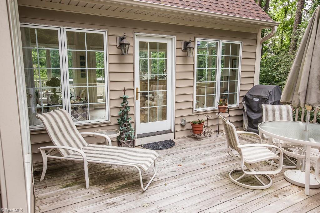5707 Roundtable Road Greensboro, NC 27407 - Photo 26 of 29 Enter onto right side deck from sunroom or kitchen. Very private. Just a couple steps from ground level. Pretty exterior lighting.
