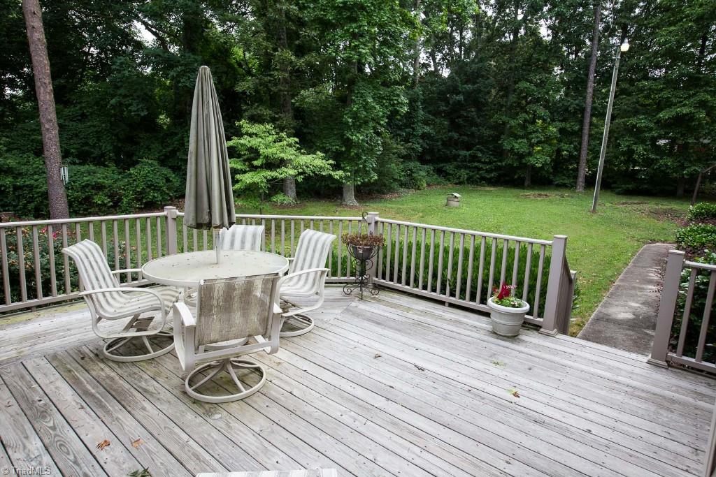 5707 Roundtable Road Greensboro, NC 27407 - Photo 27 of 29 Right side deck overlooking private, level backyard.
