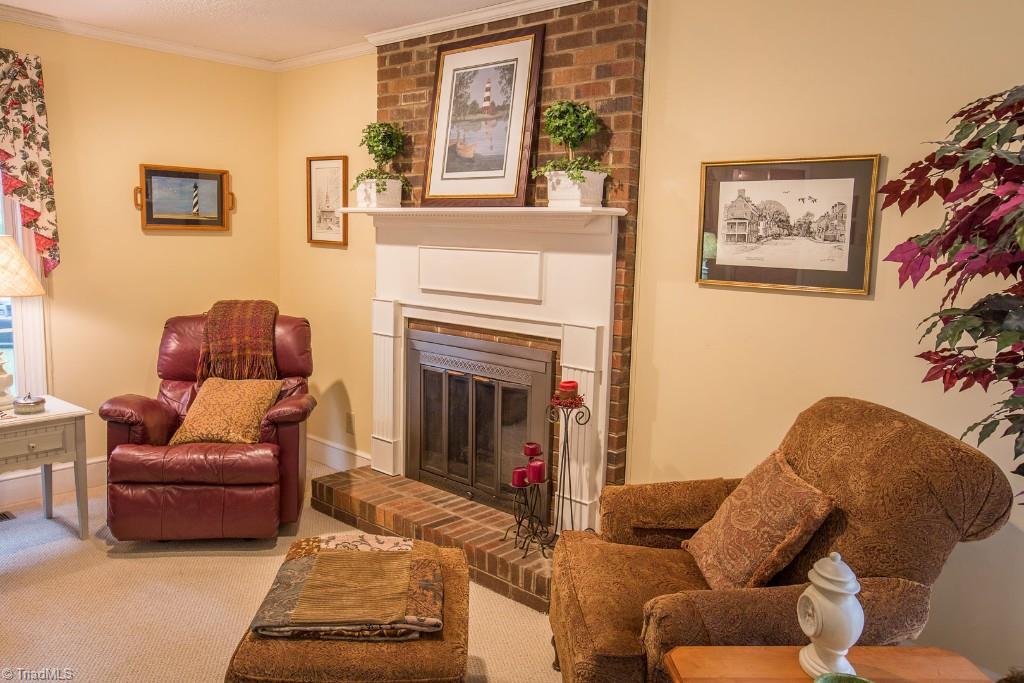 5707 Roundtable Road Greensboro, NC 27407 - Photo 8 of 29 Stunning mantel surround at masonry gas fireplace. Perfect for any season.