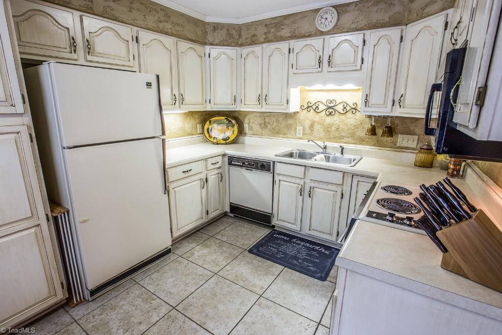 5707 Roundtable Road Greensboro, NC 27407 - Photo 9 of 29 Tuscan Kitchen with Venetian plaster in efficient U-shape. Under cabinet lighting. Over sized tile for easy clean up.