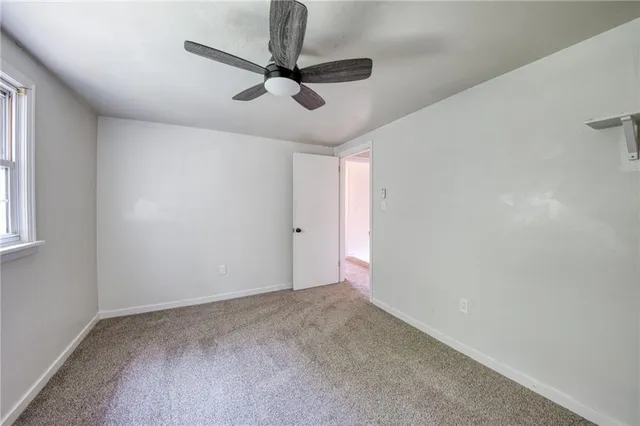 a view of a room with a ceiling fan