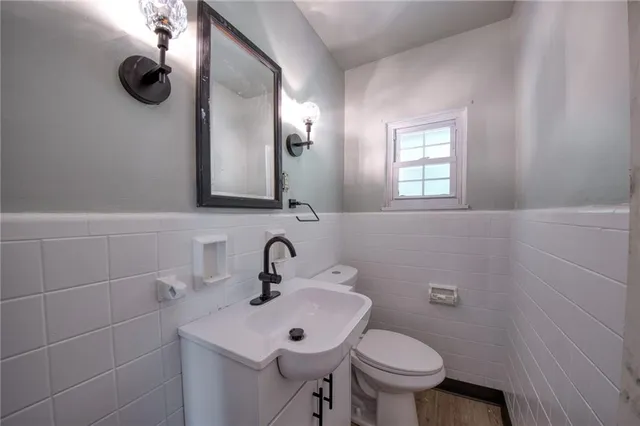 a bathroom with a toilet sink and mirror