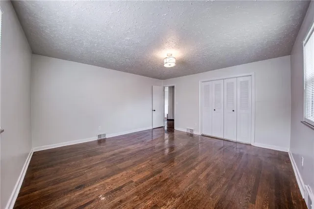 a view of an empty room and wooden floor