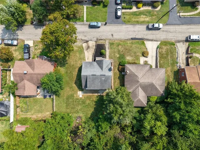 an aerial view of a house with swimming pool and outdoor seating
