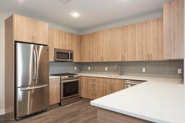 a kitchen with a refrigerator sink and microwave
