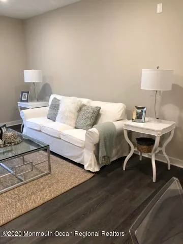 a living room with furniture a table and a lamp