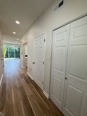 a view of a hallway with wooden floor