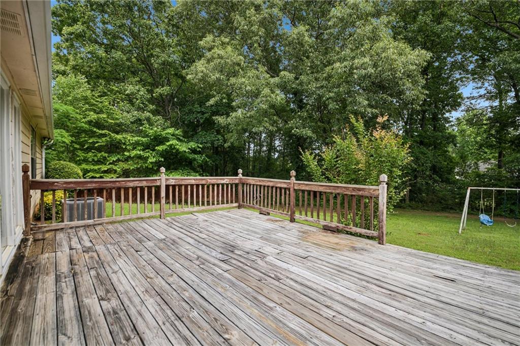 1318 Panhandle Way Hampton, GA 30228 - Photo 18 of 22 a balcony with wooden floor and fence