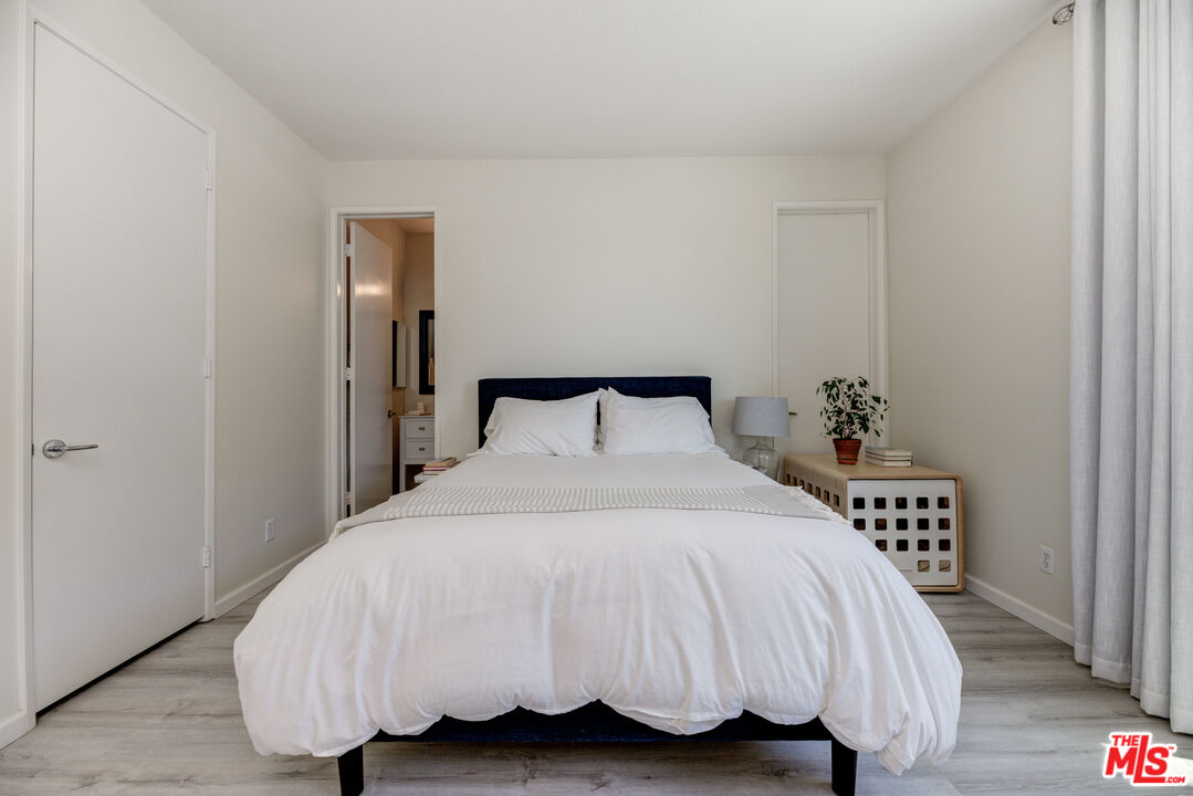 1 Northstar Street, Unit 103 Marina del Rey, CA 90292 - Photo 13 of 18 a bedroom with a bed and a potted plant