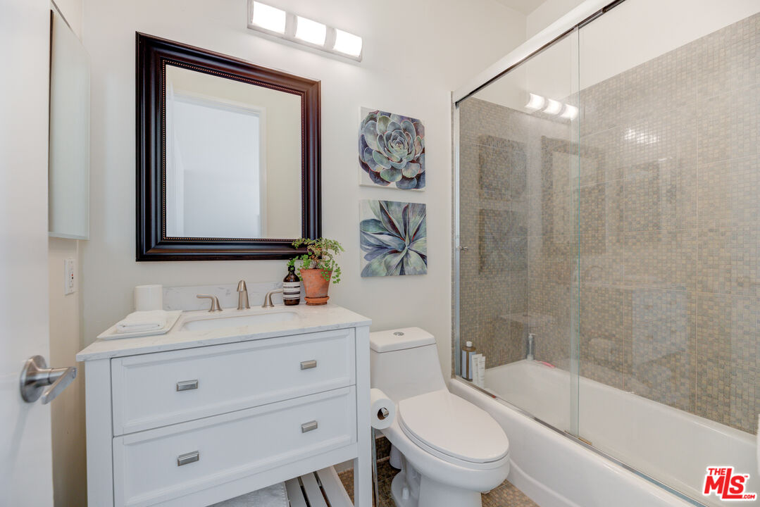 1 Northstar Street, Unit 103 Marina del Rey, CA 90292 - Photo 15 of 18 a bathroom with a toilet a sink a mirror a bathtub and vanity