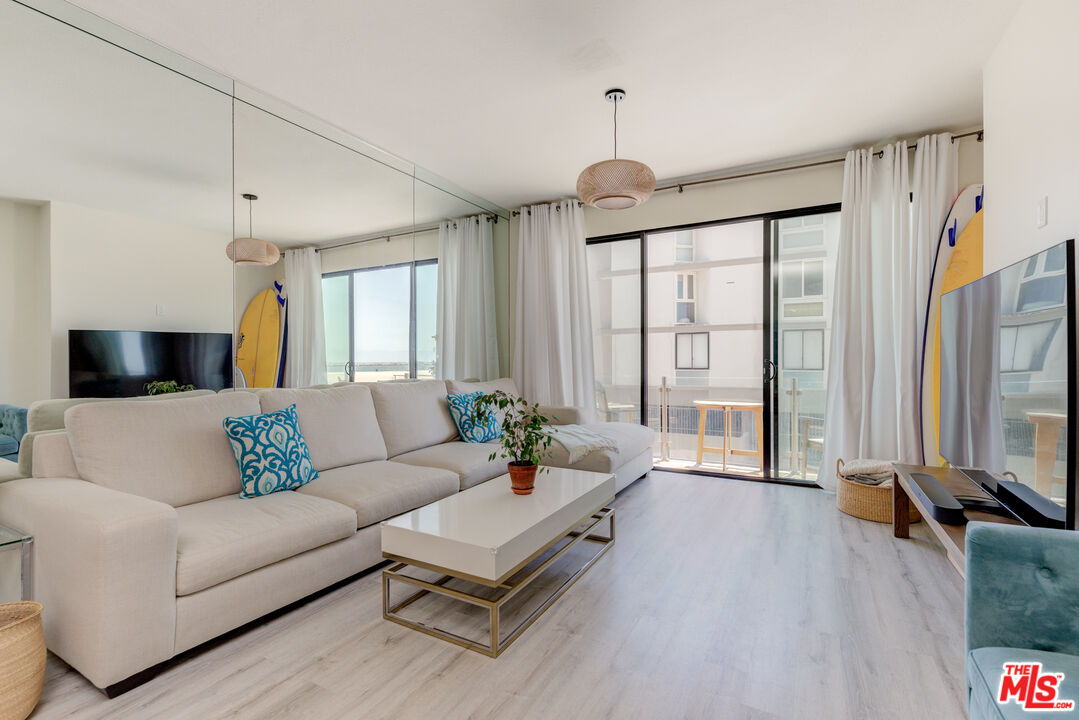 1 Northstar Street, Unit 103 Marina del Rey, CA 90292 - Photo 5 of 18 a living room with furniture and a large window