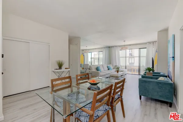 a dining room with furniture and wooden floor