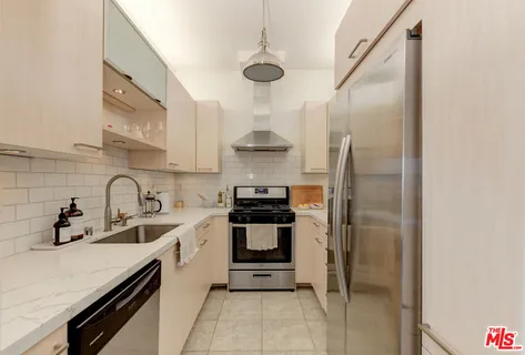 a kitchen with stainless steel appliances a stove and a refrigerator