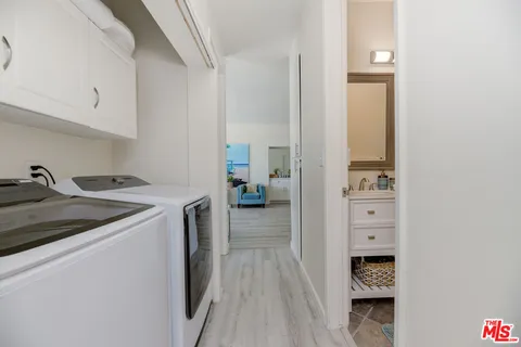 a kitchen with a sink and wooden floor