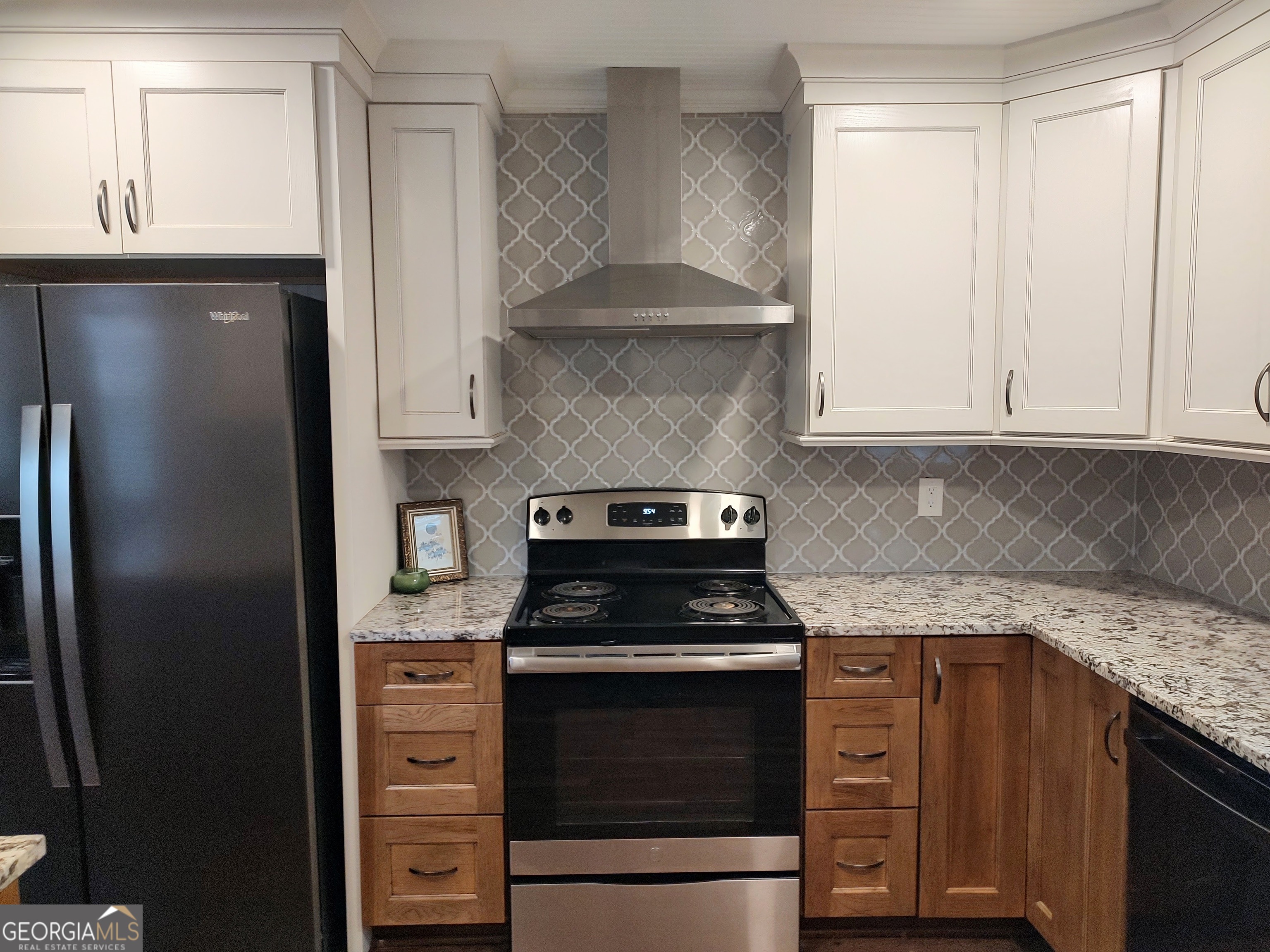 615 Hemlock Drive Thomson, GA 30824 - Photo 13 of 32 a kitchen with granite countertop white cabinets and stainless steel appliances