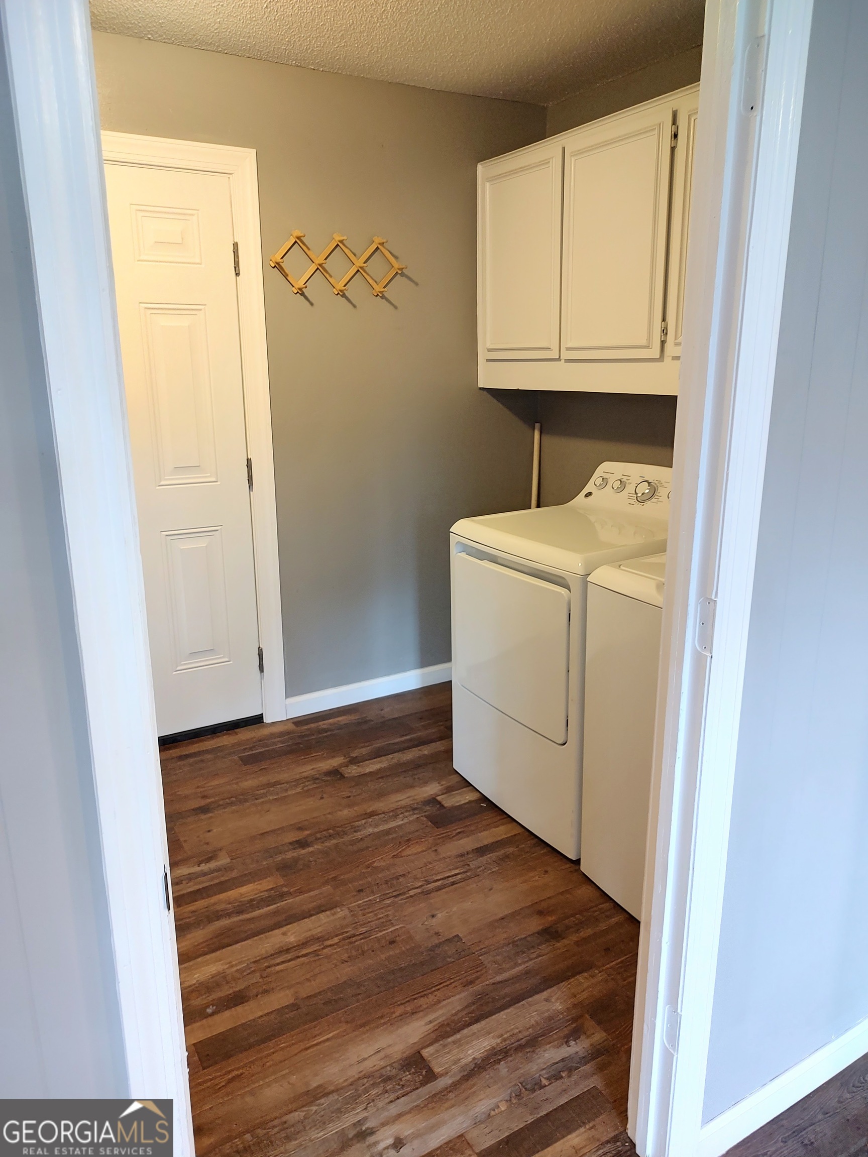615 Hemlock Drive Thomson, GA 30824 - Photo 14 of 32 a utility room with wooden floor washer and dryer