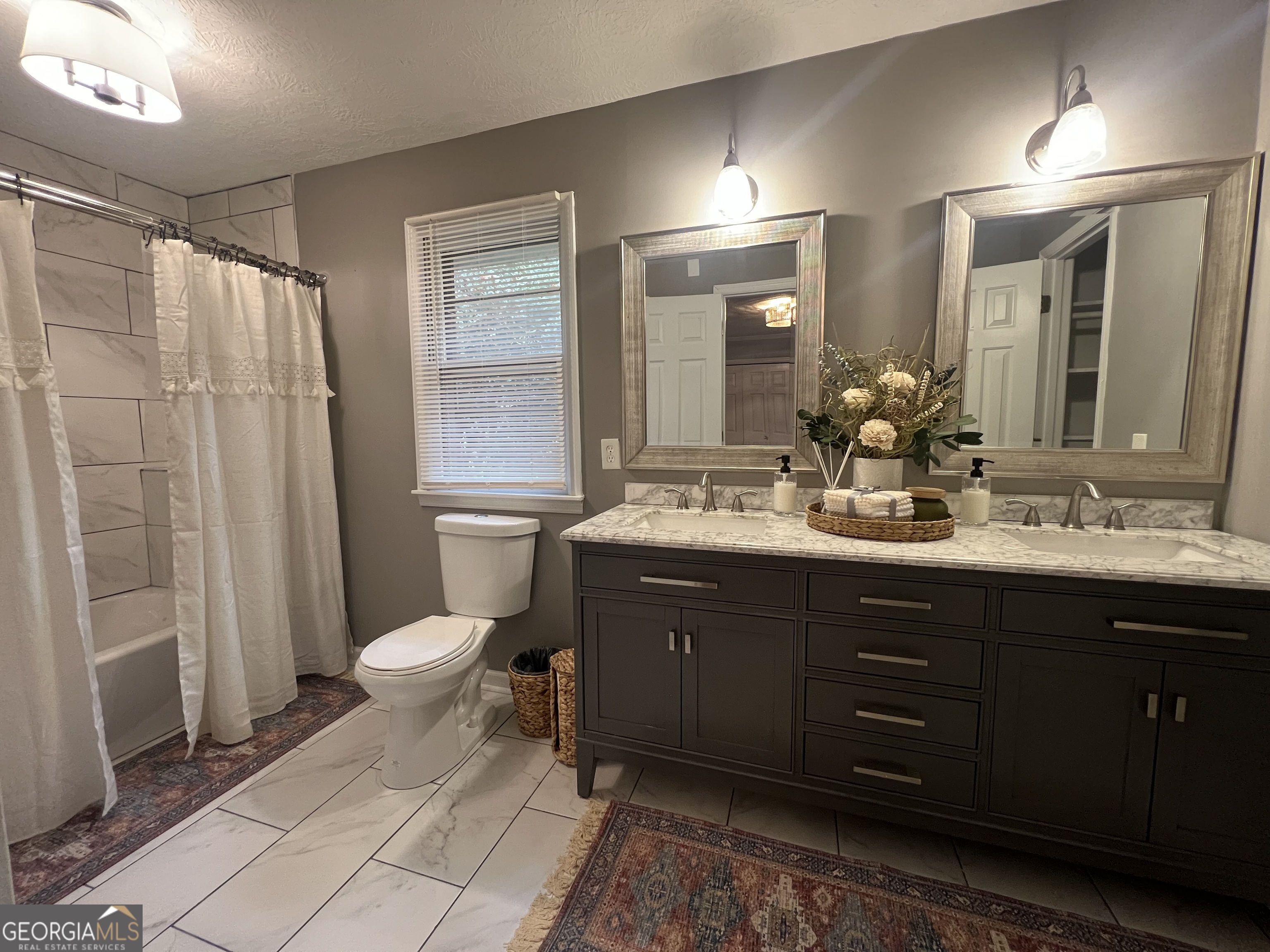 615 Hemlock Drive Thomson, GA 30824 - Photo 19 of 32 a bathroom with a double vanity sink toilet and a mirror