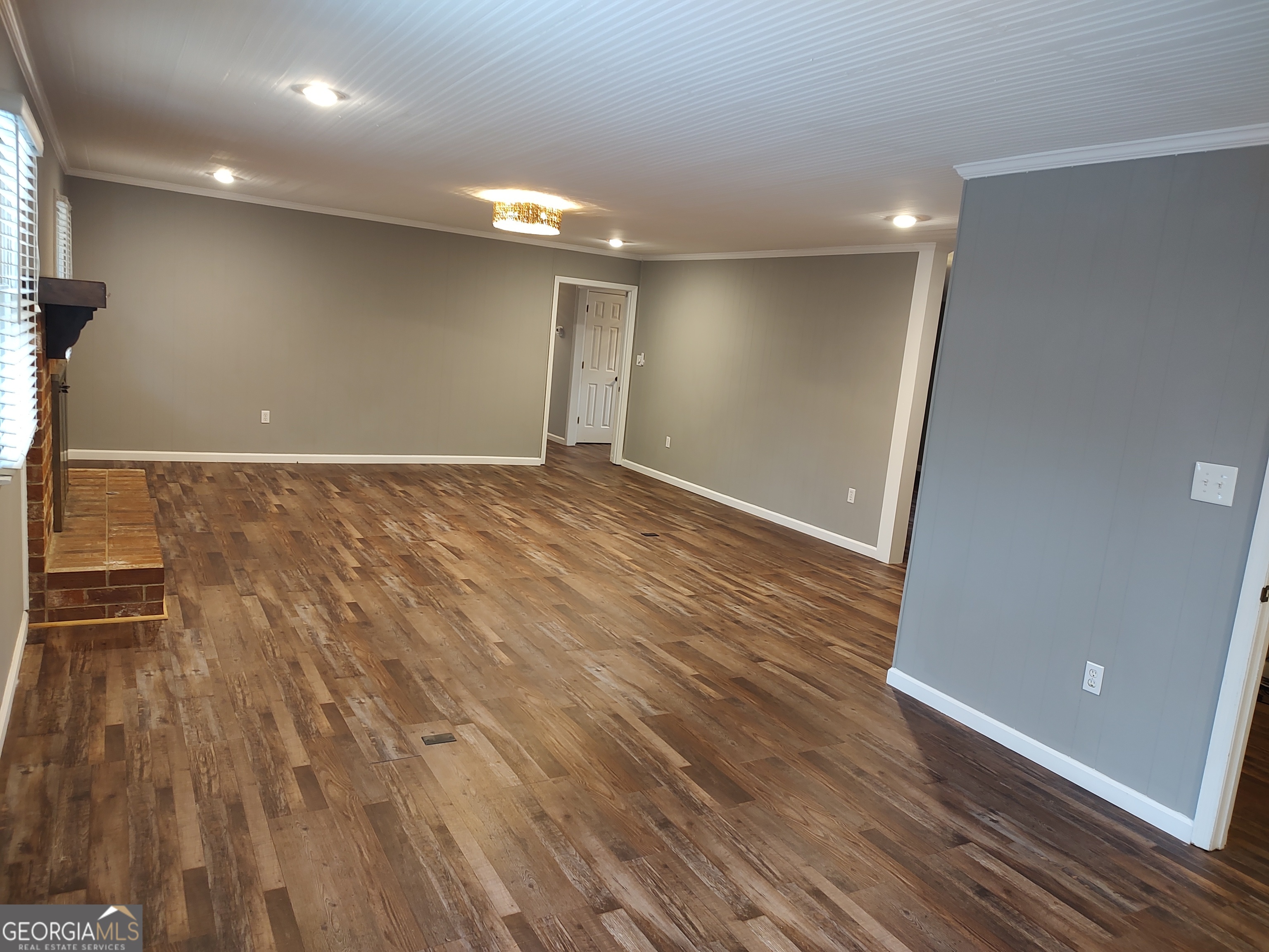 615 Hemlock Drive Thomson, GA 30824 - Photo 8 of 32 an empty room with wooden floor and windows