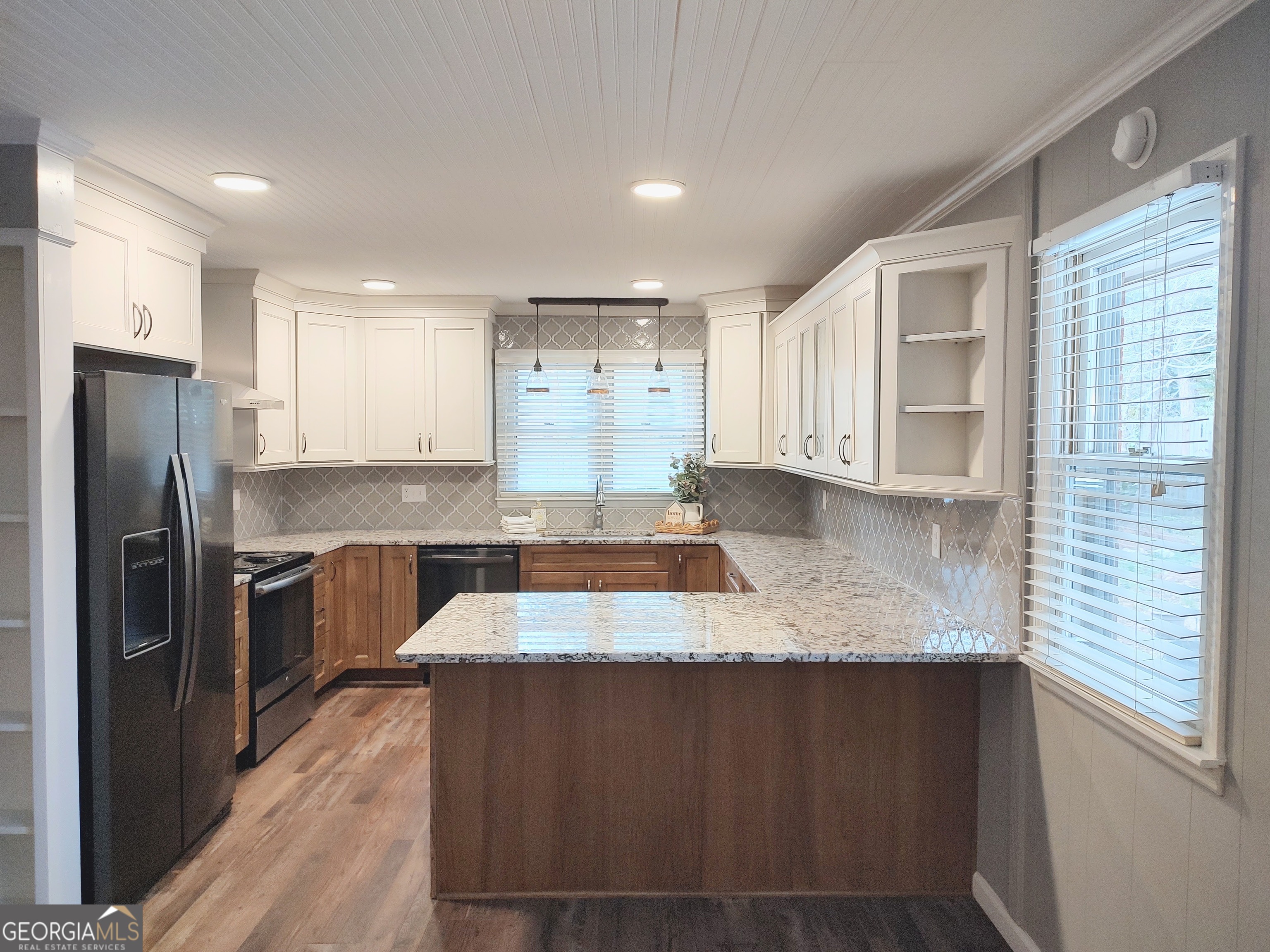 615 Hemlock Drive Thomson, GA 30824 - Photo 10 of 32 a large kitchen with granite countertop a large counter top stainless steel appliances and cabinets
