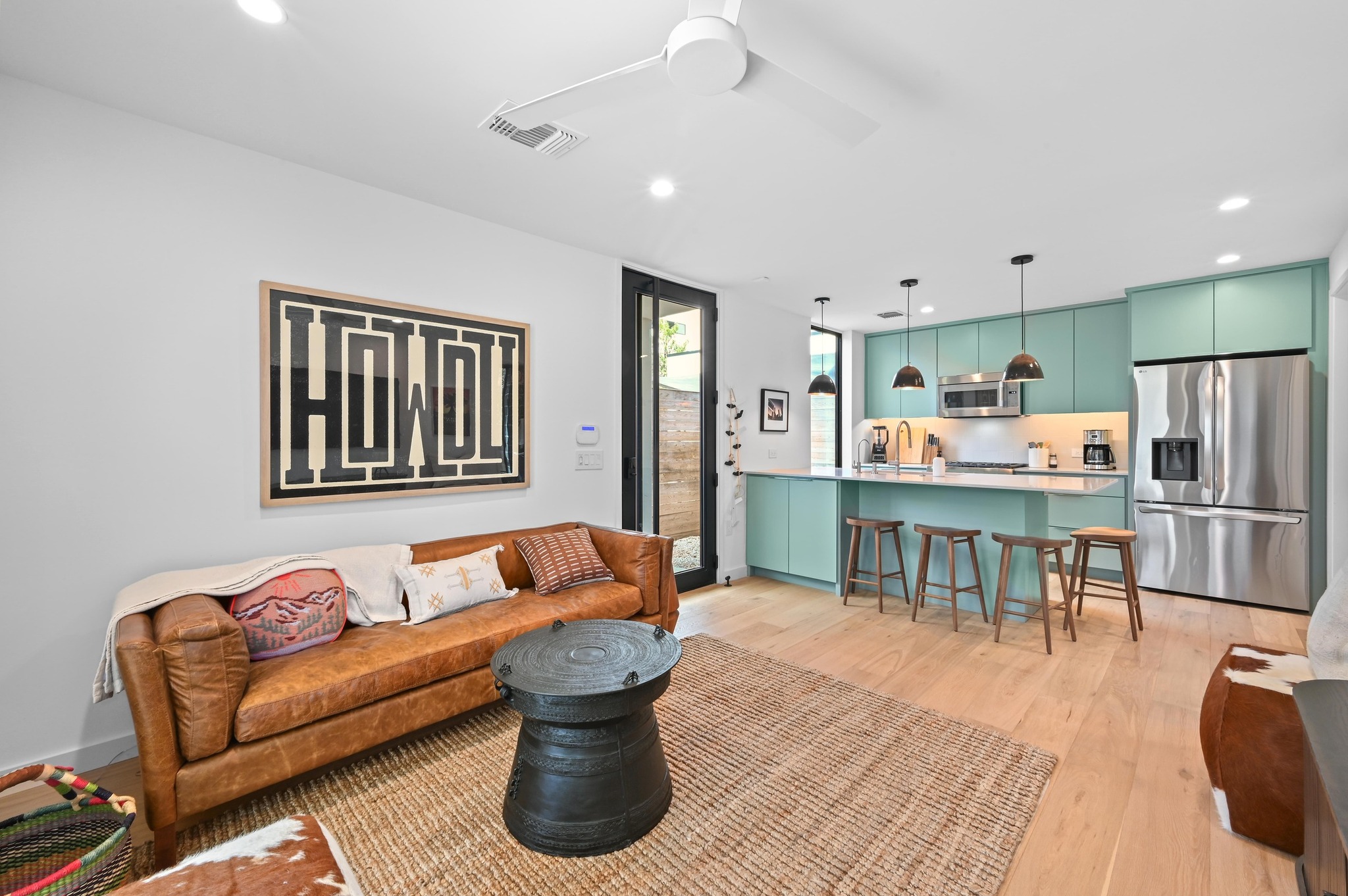 a living room with stainless steel appliances kitchen island granite countertop furniture and a kitchen view