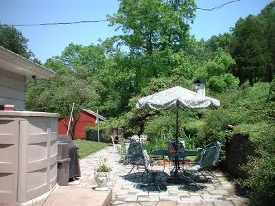 7525 Hahn Road Bangor, PA 18013 - Photo 4 of 10 a view of a patio with table and chairs under an umbrella