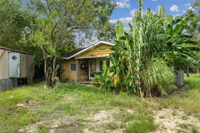 a backyard of a house with table and chairs