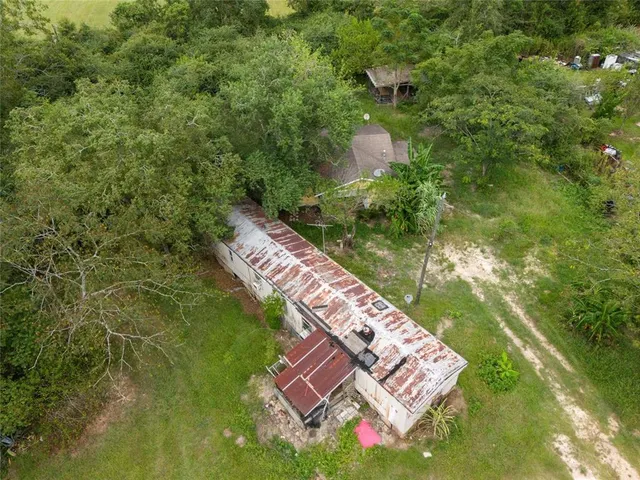 a backyard of a house with lots of green space and fountain