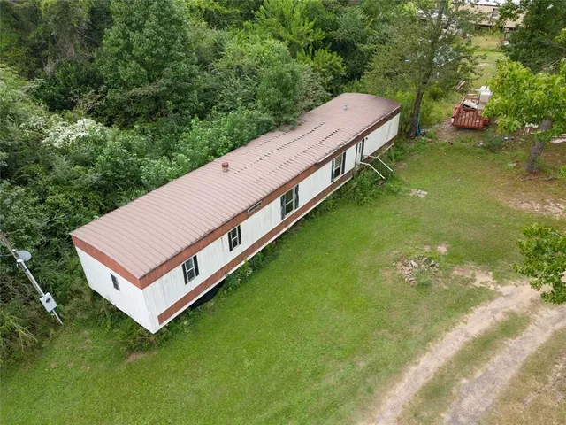 a view of a house with a backyard