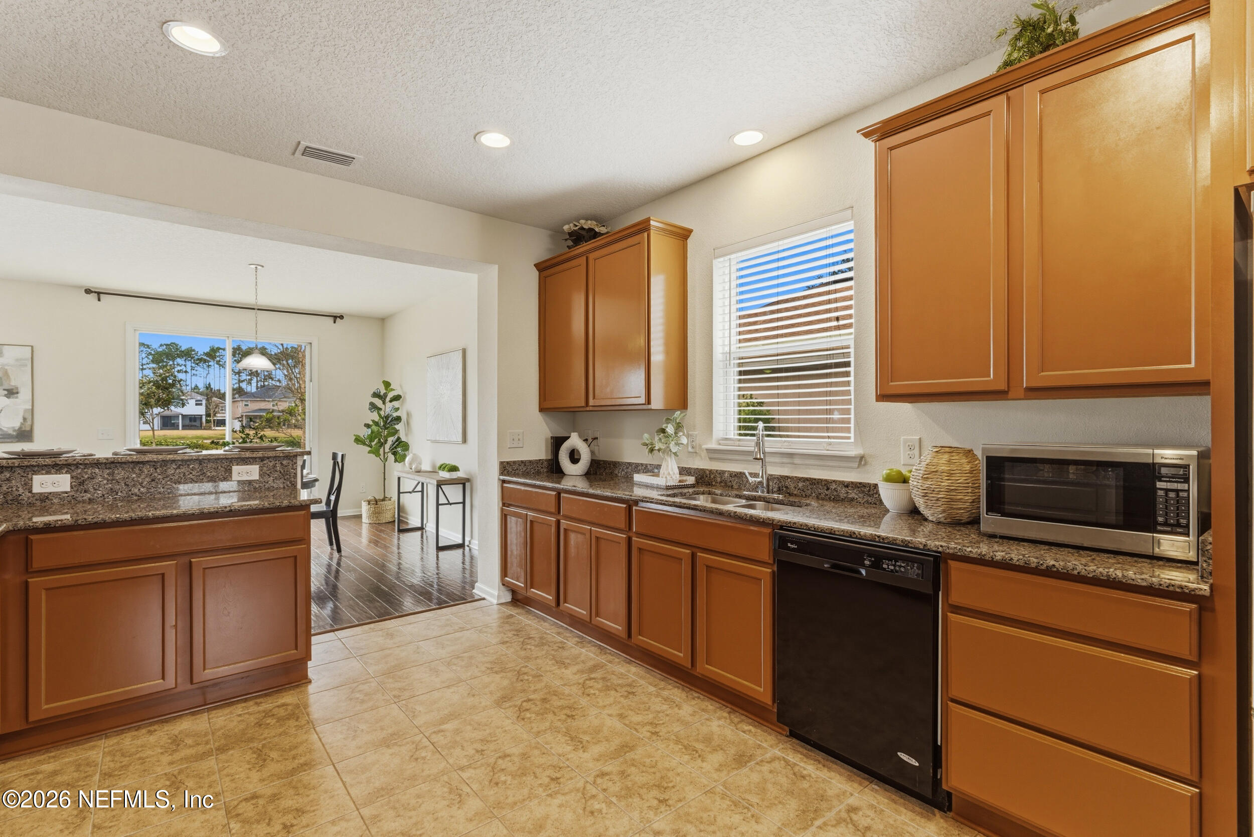 270 Carnation Street St. Johns, FL 32259 - Photo 13 of 56 a kitchen with stainless steel appliances granite countertop sink stove top oven and cabinets