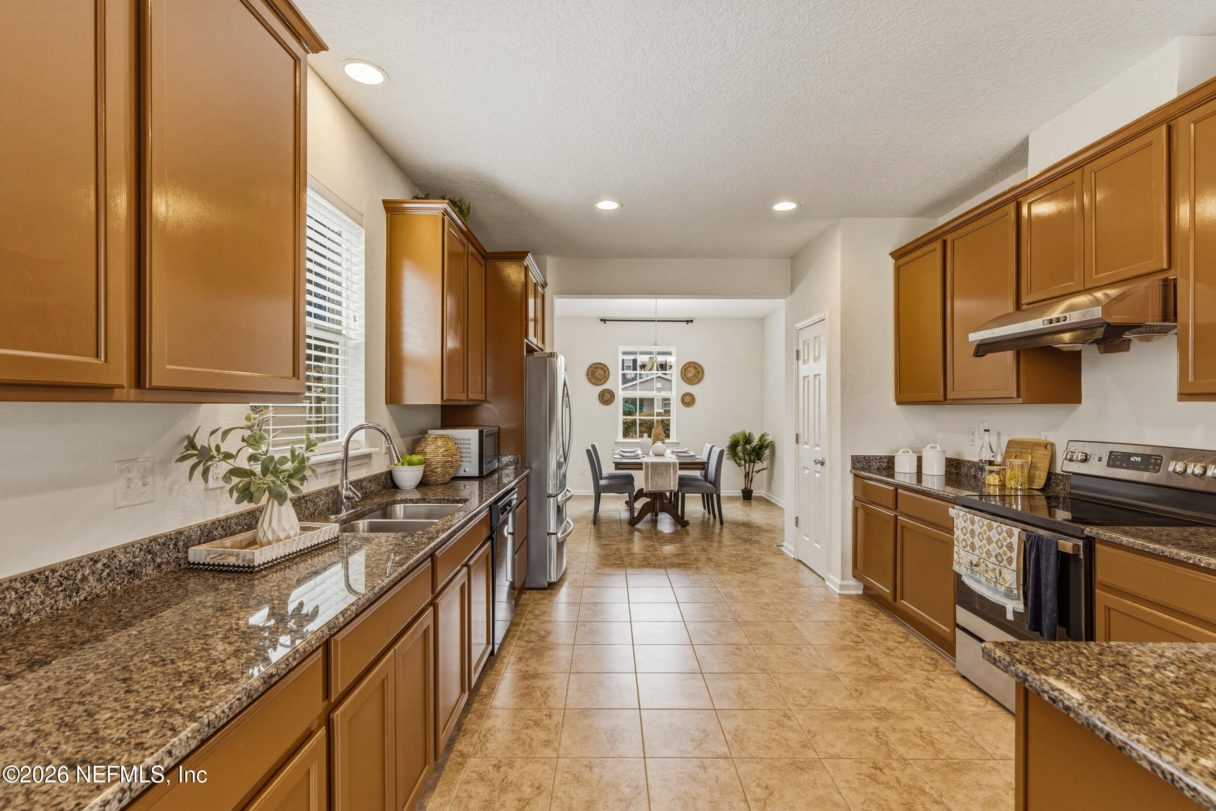 270 Carnation Street St. Johns, FL 32259 - Photo 15 of 56 a kitchen with granite countertop sink stove and cabinets