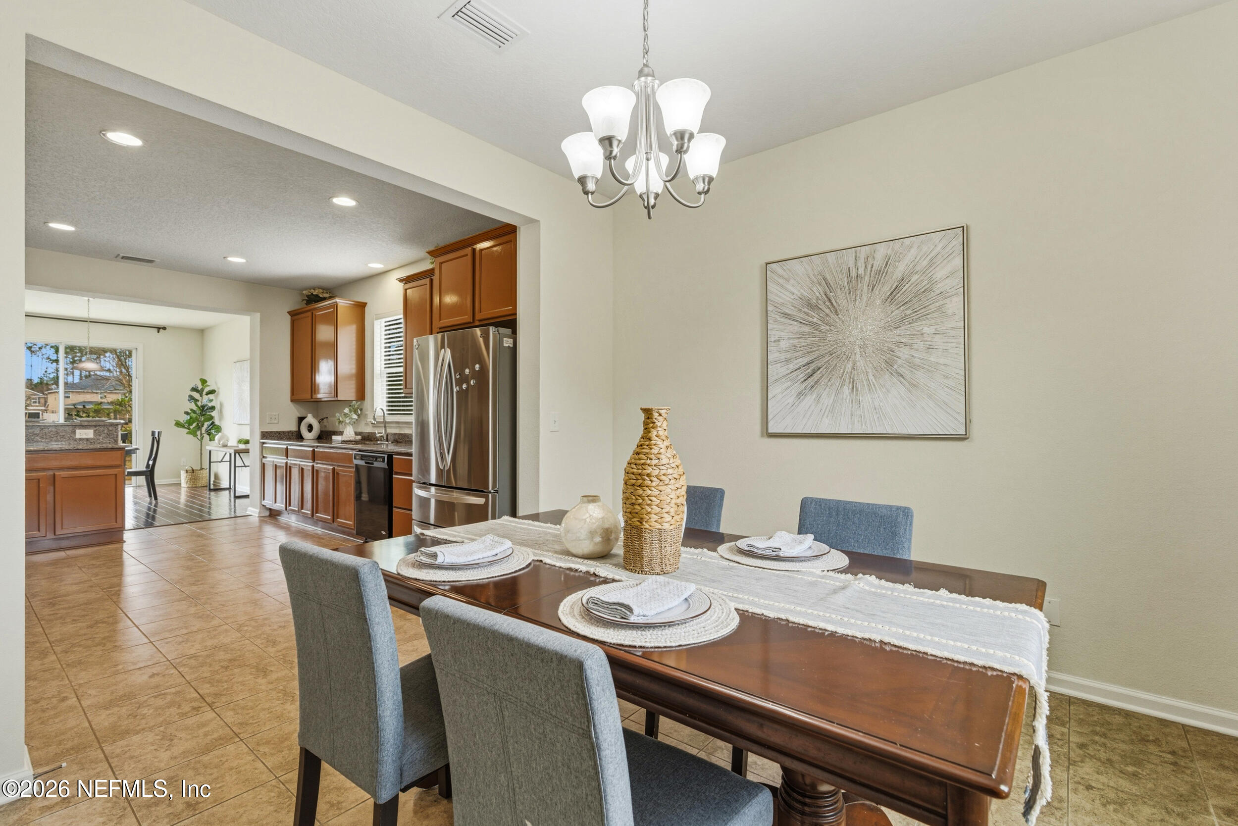 270 Carnation Street St. Johns, FL 32259 - Photo 17 of 56 a view of a dining room with furniture a chandelier and wooden floor