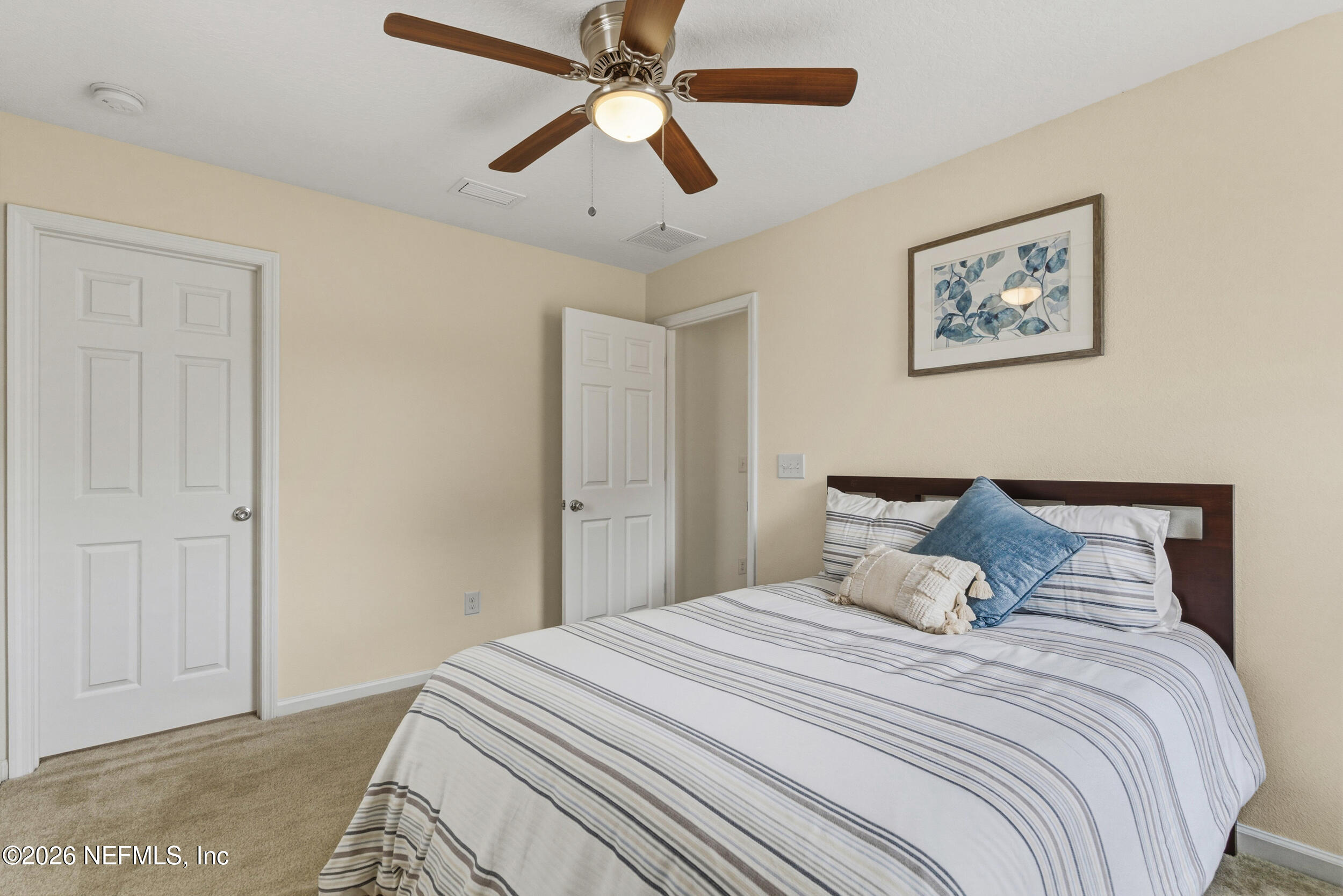 270 Carnation Street St. Johns, FL 32259 - Photo 30 of 56 a bedroom with a large bed and a chandelier