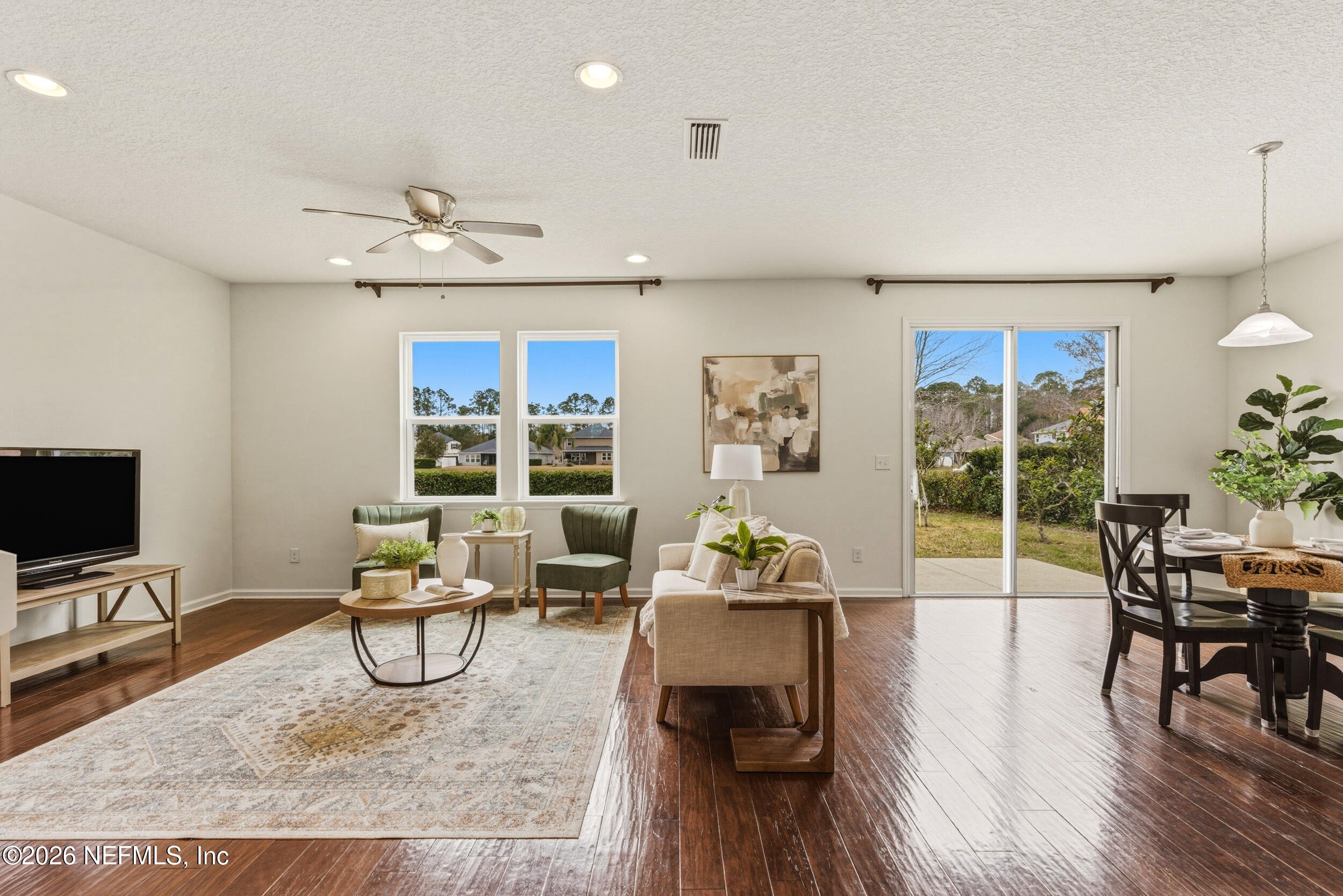270 Carnation Street St. Johns, FL 32259 - Photo 4 of 56 a living room with furniture a dining table and a flat screen tv