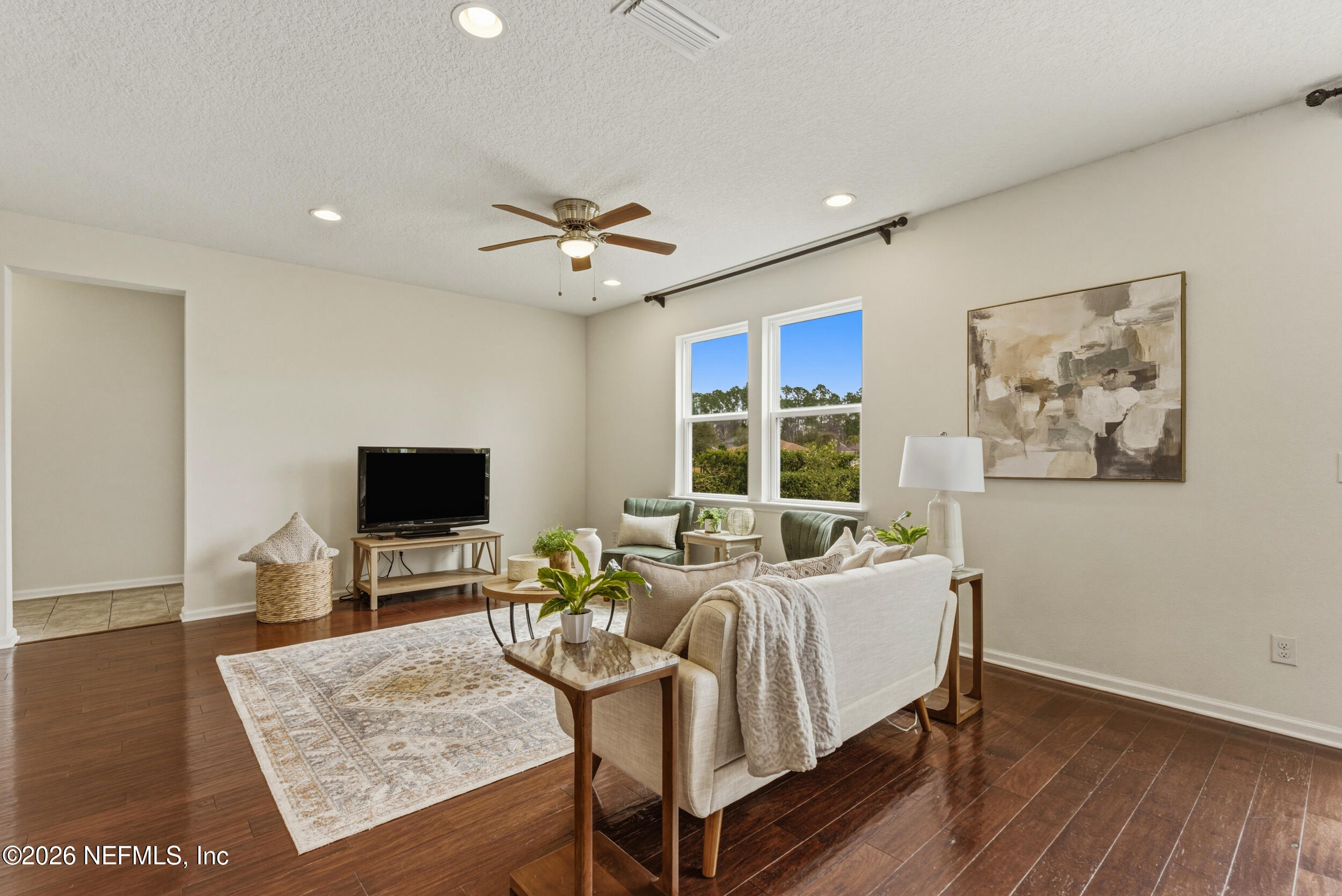 270 Carnation Street St. Johns, FL 32259 - Photo 8 of 56 a living room with furniture a flat screen tv and a fireplace