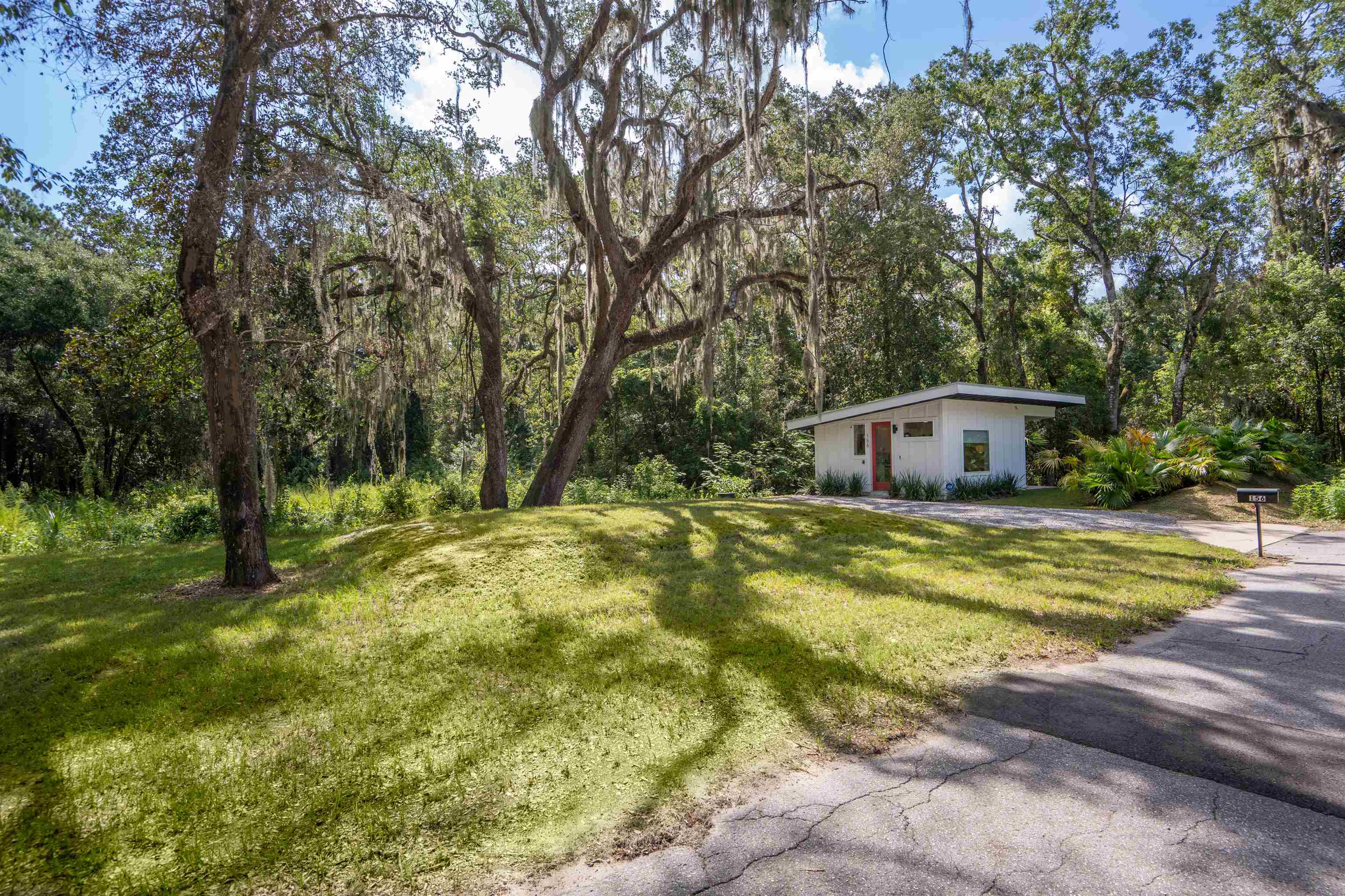 156 North St Johns Street St. Augustine, FL 32084 - Photo 1 of 14 a backyard of a house with trees and entertaining space