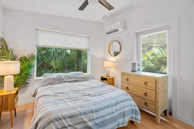 a spacious bedroom with a bed and a large window