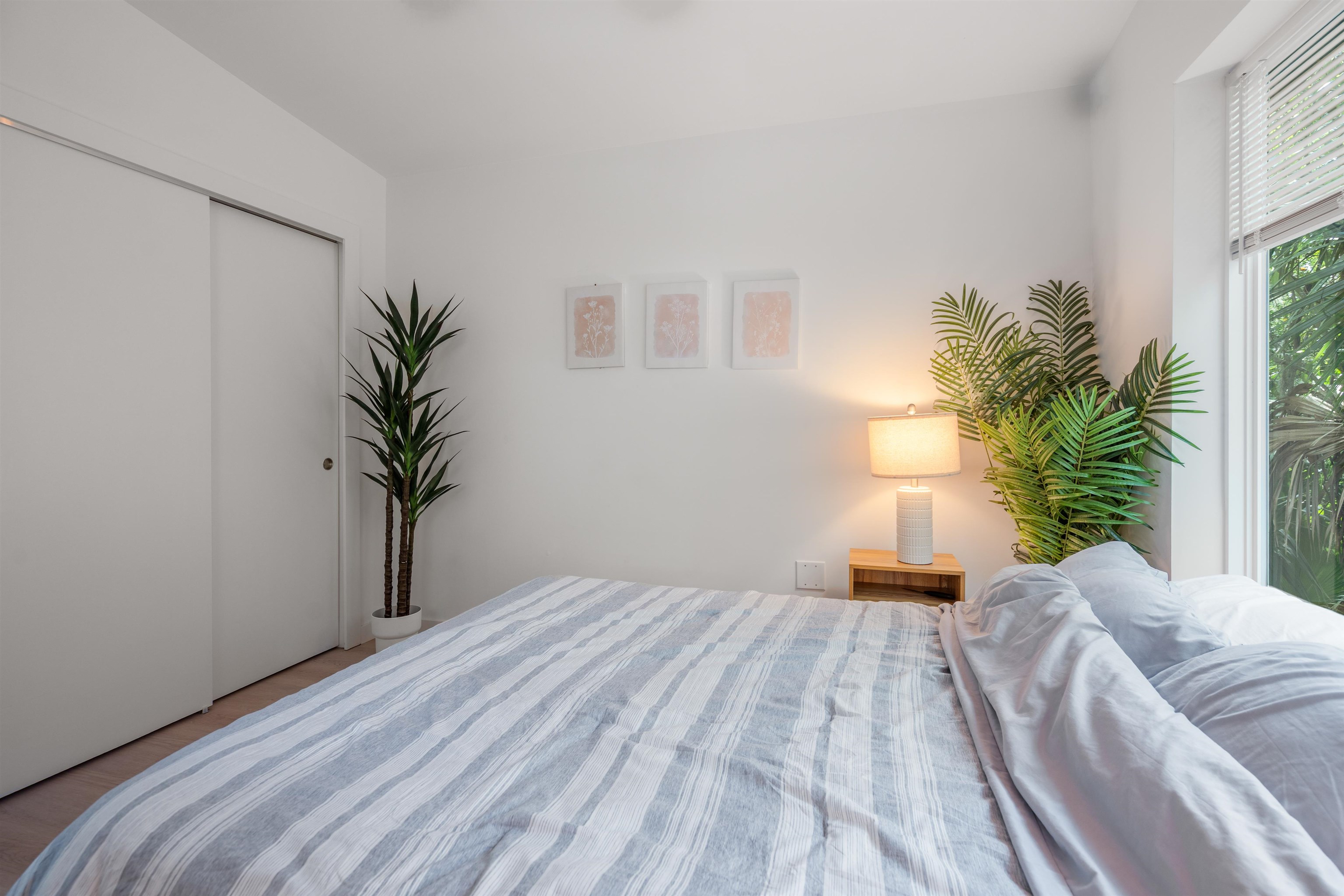 156 North St Johns Street St. Augustine, FL 32084 - Photo 13 of 14 a bedroom with a large bed and a potted plant